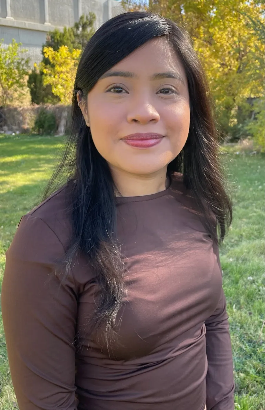 alondra headshot, outside, wearing brown longsleeve shirt